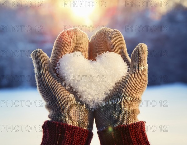 Serene winter scene showcasing hands in gloves holding a snow heart symbolizing love and warmth, AI