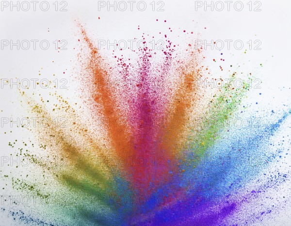 Vibrant and energetic multicolored powder explosion captured against awhite background. Evoking