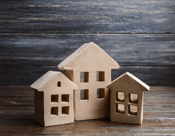 A collection of small model houses with cozy lighting, creating a warm and inviting atmosphere, AI
