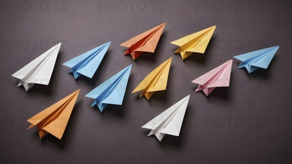 Colorful paper planes arranged in organized pattern, symbolizing creativity, playfulness,