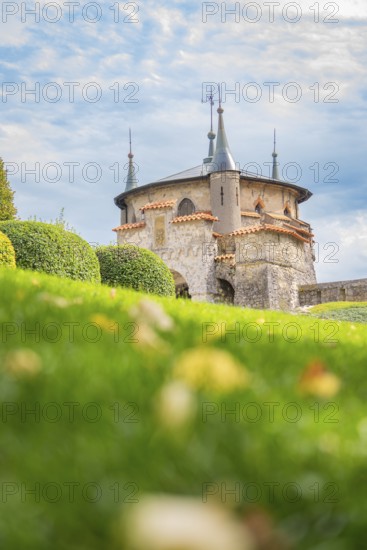 Beautiful castle with pewter towers and manicured lawns under a blue sky, Lichtenstein Castle,