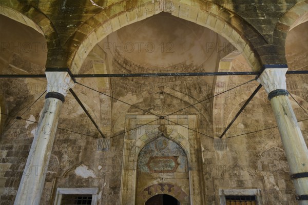 Interior with antique arcades and stone decorations in a historic building, Recep Pasha Mosque, Old