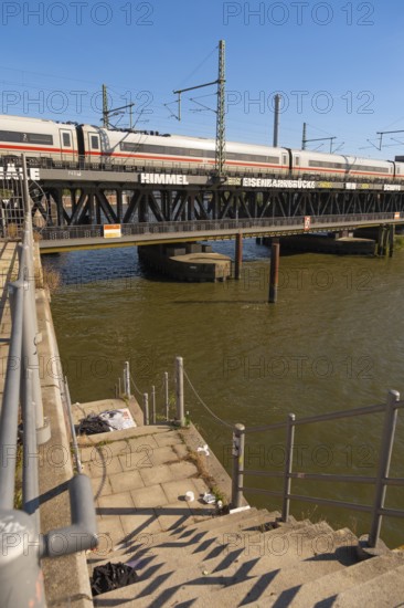 Dilapidated staircase to Oberehafen and Ericusgraben with a view of the Oberhafen bridge over which