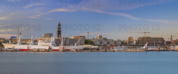 View over the Norderelbe to the main church St. Michaelis and the Landungsbrücken with ships in