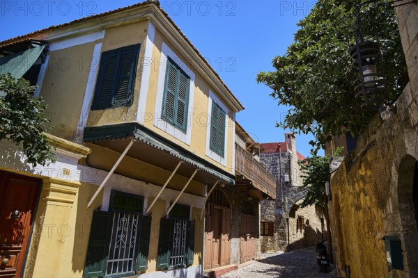 Colourful house facades with shutters in a historic alley, Turkish Quarter, Rhodes Old Town, Rhodes