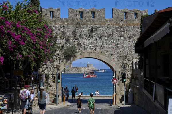 Panagia Tor, natural stone archway with a view of the sea and passing tourists, Rhodes Old Town,