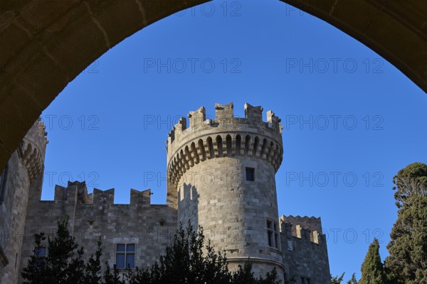 Tor tor Grand Master's Palace, castle with imposing tower and battlements, framed by a strong blue