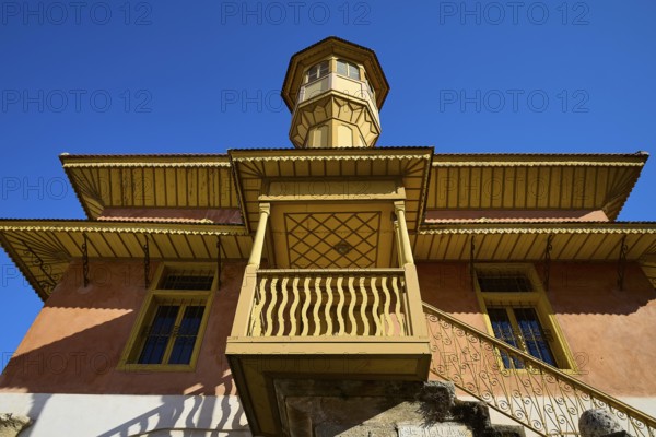 Ottoman building with wood-decorated tower and balconies that stand out majestically against the