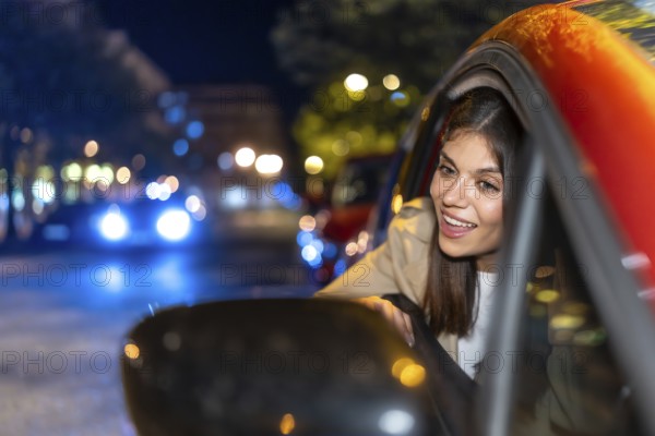 Woman looking out car window enjoying a vibrant city night with blurred lights creating bokeh,