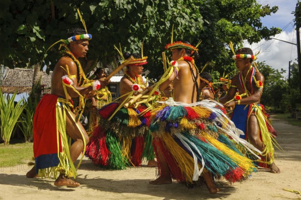 Traditional group of dancers from Yap Island dancing in historical traditional costume with
