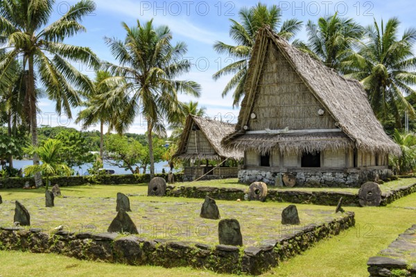 Traditional houses in museum village of Yap Island in front of dance area wonbey for traditional