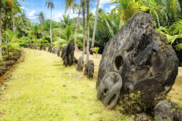 Oversized large giant stone coins real currency in stone money bank stone money bank in jungle of