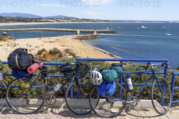 Bicycles with luggage, above the beach Praia da Batata, in the city centre of Lagos, in the west of