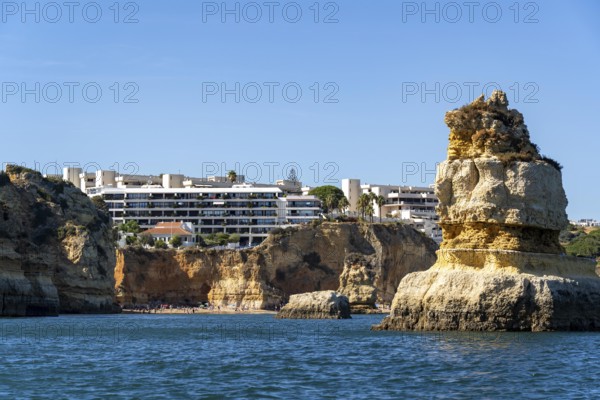 Praia Dona Ana beach, hotel buildings, Ponta da Piedade rocky coast, rugged coastal landscape,