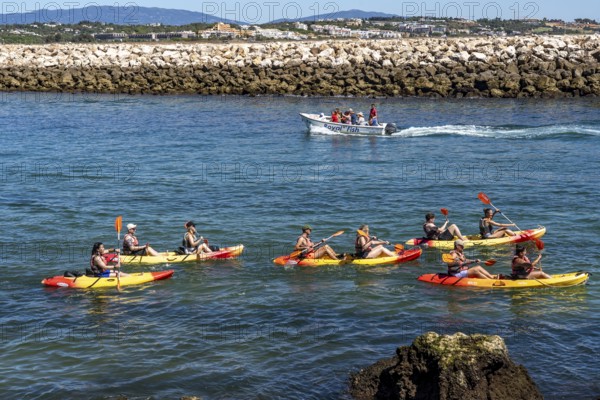 Kayak tours to the rocky coast of Ponta da Piedade, groups of tourists kayak on the sea to the