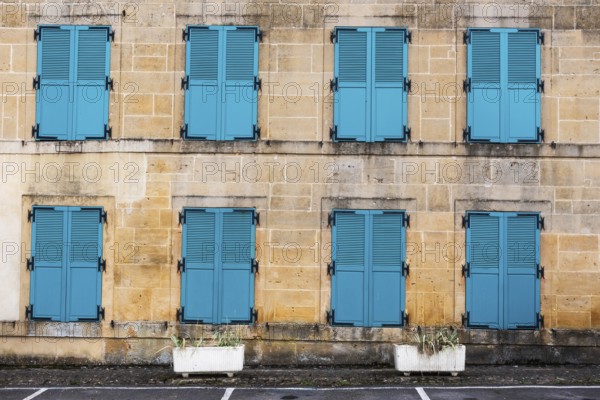 Closed, green shutters, historic house facade, yellow sandstone, Marville, Renaissance village,