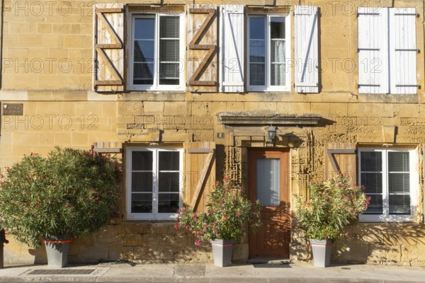 Renovated building, historic house façade, yellow sandstone, Marville, Renaissance village,