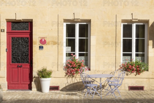 Entrance decorated with flowers, table and chairs, Marville, Renaissance village, Département