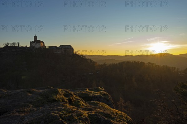 View of Wartburg Castle with the setting sun and the Thuringian Forest, Eisenach, Thuringia,