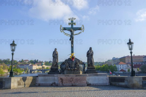 Statuary of the Holy Crucifix and Calvary on Charles Bridge, in Prague, Czech Republic, in sunny