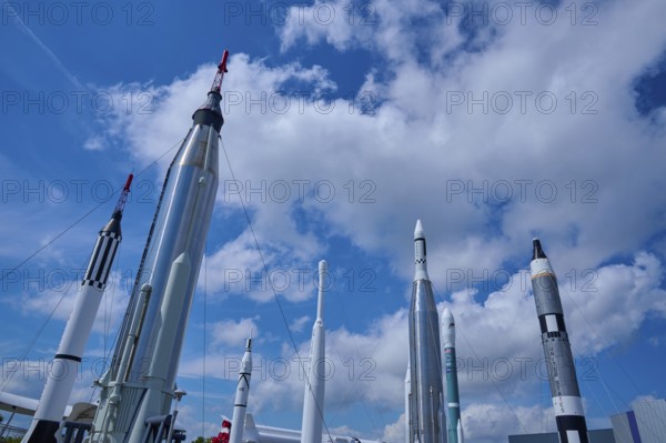 Various rockets rising into the blue sky, surrounded by clouds, Kennedy Space Centre Visitor