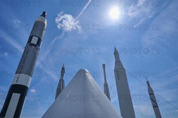 Rockets under bright sunshine, with a cloud in the blue sky, Kennedy Space Centre Visitor Complex,