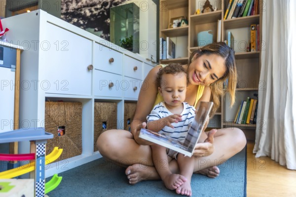 Happy mother and baby son sharing a joyful moment while reading a book together, creating lasting