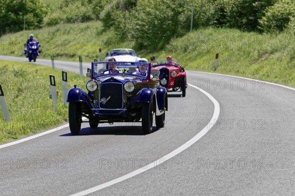 A blue and a red classic car driving one behind the other on a road, classic car, car race, Mille