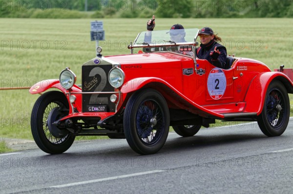 Red vintage car with a smiling woman on a rural road, vintage car, car race, Mille Miglia, 1000