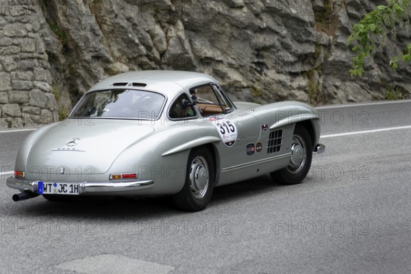 No.315, Merdedes-Benz 300SL W 198, year 1954, Silver classic car driving on a road with rocks in