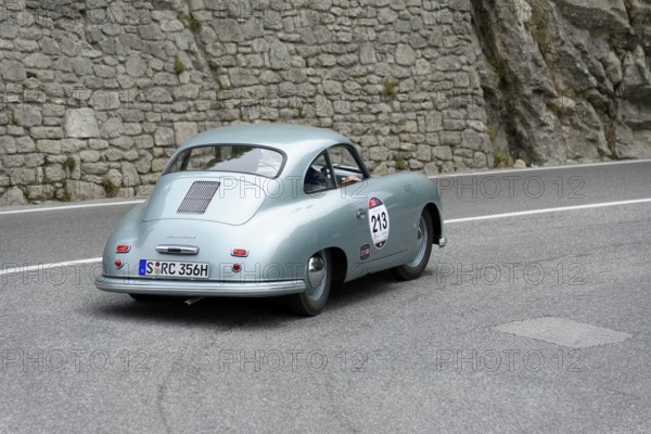No. 213, Porsche 356 1100 Coupé, model year 1951, Blue vintage car drives past rocks on a winding