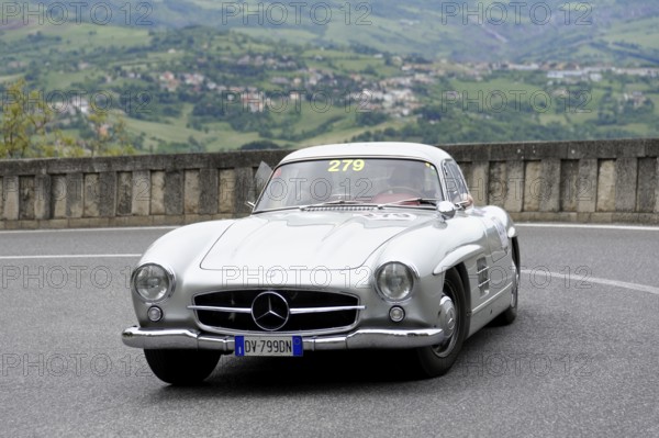 No.279, Mercedes-Benz 300 SL W 198, model year 1954, Silver vintage car driving on a winding road