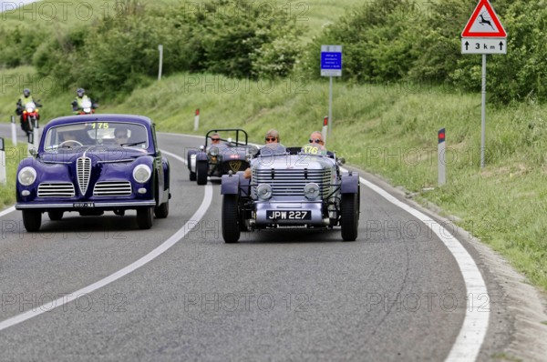 Purple vintage car and black car driving side by side on country road, vintage car, car race, Mille