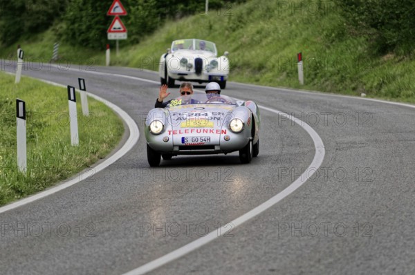 Classic car with two people on a winding country road, classic car, car race, Mille Miglia, 1000