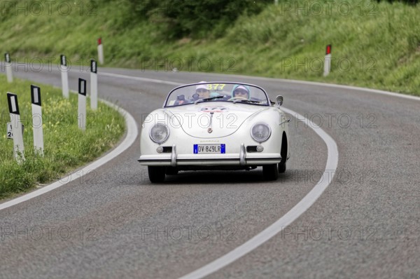 White Porsche vintage convertible on a winding country road, classic car, car racing, Mille Miglia,
