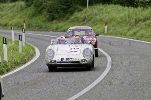 Open-top classic car followed by another car on a country road, classic car, car race, Mille