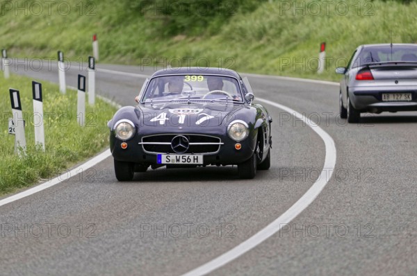 Black Mercedes classic car on a winding country road during a race, classic car, car race, Mille