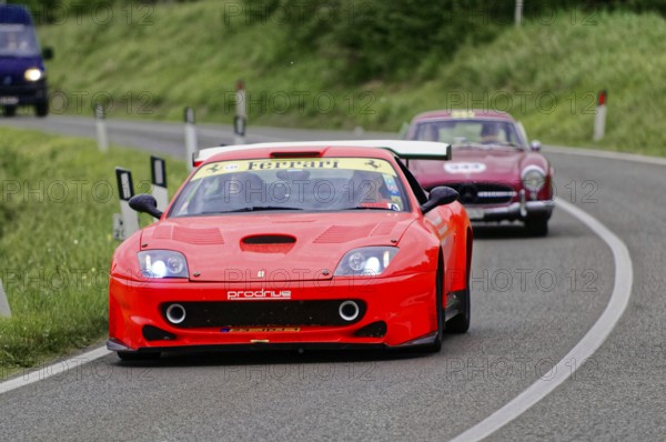 A red Ferrari racing car drives dynamically in front of a classic car, classic car, car race, Mille