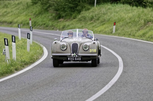 Classic vintage car with two occupants on a country road, vintage car, car race, Mille Miglia, 1000