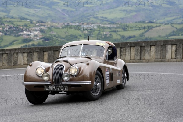 No. 236, Jaguar XK 120 Coupé, year of construction 1952, Brown vintage car driving on a winding