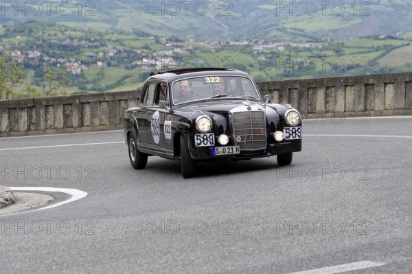 No. 322, Mercedes-Benz 220A, model year 1955, black vintage car driving on a winding road through a