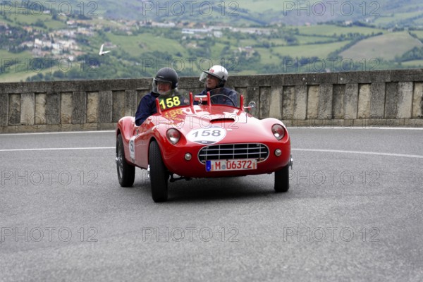 Stanguellini 1100 Sport, built in 1948, red vintage sports car with two occupants on a winding