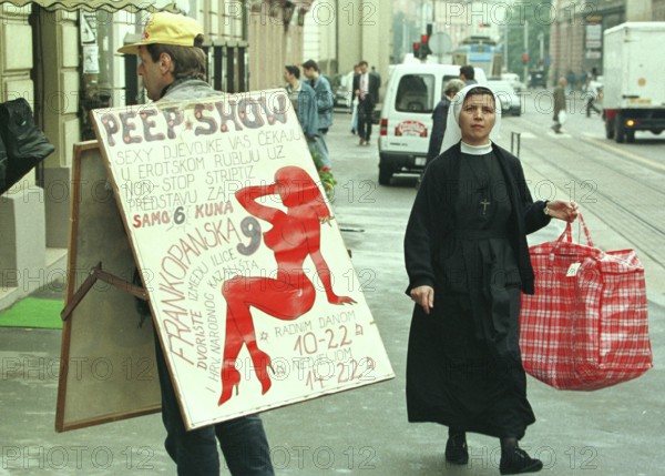 HRV, Zagreb, 01.05.1995 -- A Catholic nun meets a sex shop advertiser in Zagreb. -- A catholic now