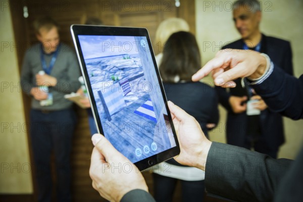 ITA Italy Castelfalfi participants try out a virtual tour via pad during a conference for tourism