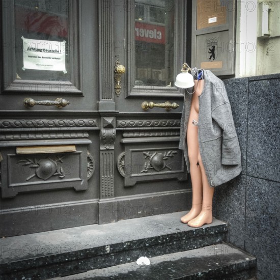 DEU Germany Germany Berlin Half a shop window doll is standing, decorated with lamp and mantle, in