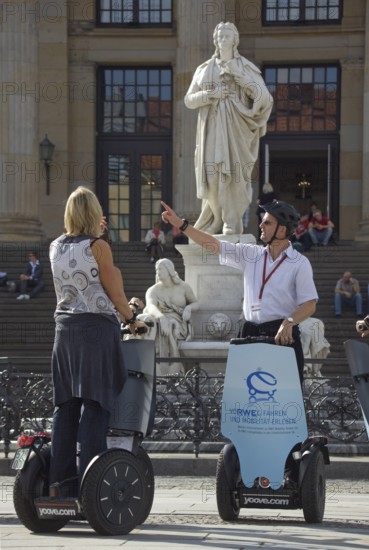 GERMANY Berlin Segway drivers during a guided city tour in front of the Schiller Monument on the