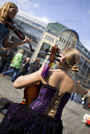 GERMANY Berlin Street musicians in corsets play violin and cello at Hackescher Markt. Germany
