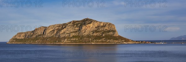 Massive rocky island juts out of the still sea in the afternoon, Monemvasia, Monemvassia, Malvasy,
