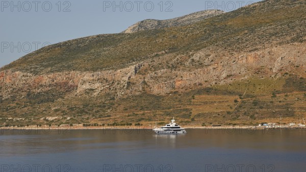 Yacht on calm water in front of a landscape with rocky mountains, Monemvasia, Monemvassia, Malvasy,