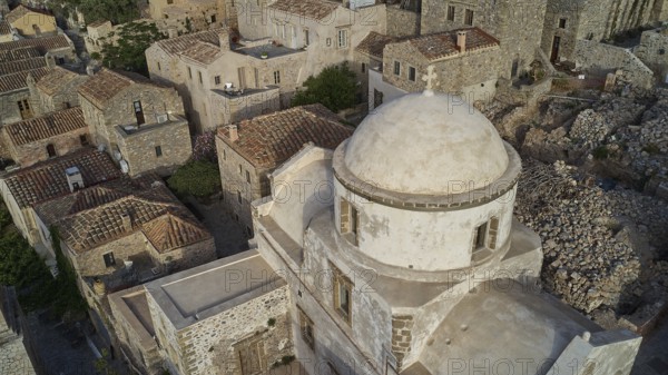 Drone view, historic church with dome surrounded by a village, taken from the air, Monemvasia,